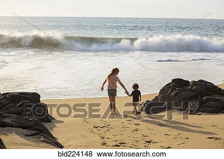 Caucasian brother and sister holding hands on beach View Large Photo Image Stock Photo - Caucasian brother and sister holding hands on beach. Fotosearch