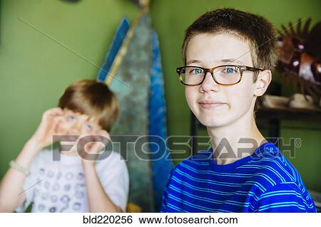 Caucasian brothers smiling in living room View Large Photo Image Stock Photograph - Caucasian brothers smiling in living room. Fotosearch