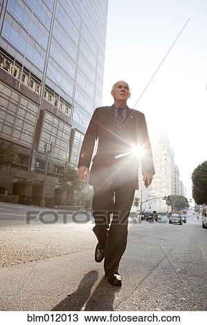 Caucasian businessman crossing urban street View Large Photo Image Stock Image - Caucasian businessman crossing urban street. Fotosearch