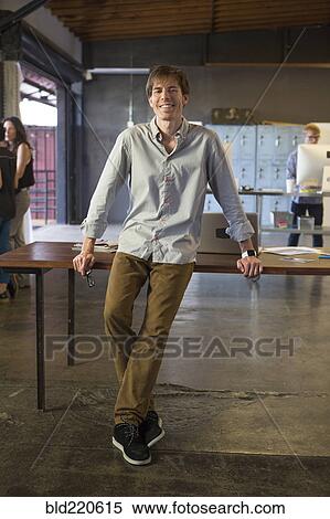 Stock Photography - Caucasian businessman smiling in office. Fotosearch
