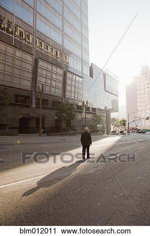 Caucasian businessman standing in deserted urban area View Large Photo Image Stock Image - Caucasian businessman standing in deserted urban area. Fotosearch