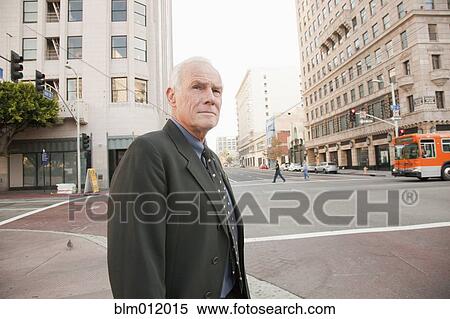 Caucasian businessman standing on urban sidewalk View Large Photo Image Stock Photography - Caucasian businessman standing on urban sidewalk. Fotosearch