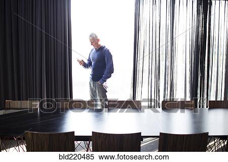 Caucasian businessman using cell phone in conference room View Large Photo Image Stock Photography - Caucasian businessman using cell phone in conference room. Fotosearch