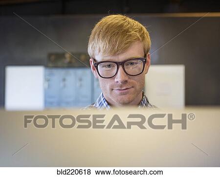 Stock Photo - Caucasian businessman working on computer. Fotosearch