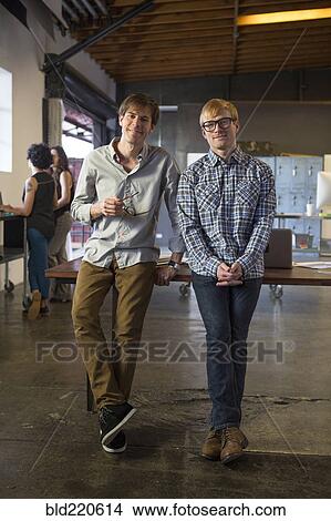 Picture - Caucasian businessmen smiling in office. Fotosearch