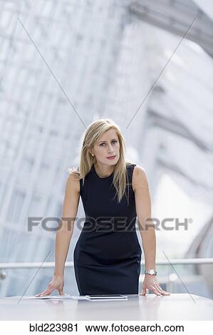 Caucasian businesswoman leaning on table in conference room View Large Photo Image Stock Image - Caucasian businesswoman leaning on table in conference room. Fotosearch