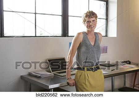Stock Image - Caucasian businesswoman standing in office. Fotosearch