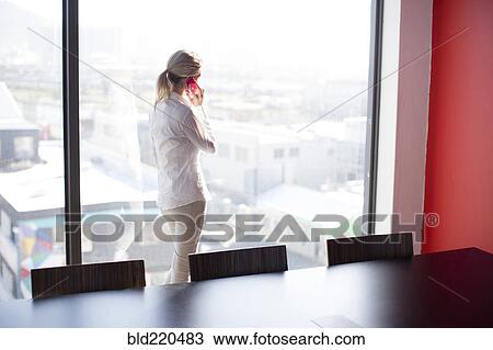 Caucasian businesswoman talking on cell phone in conference room View Large Photo Image Stock Image - Caucasian businesswoman talking on cell phone in conference room. Fotosearch