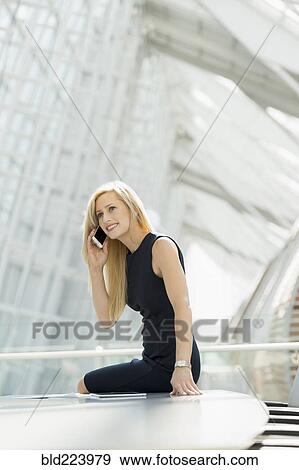 Caucasian businesswoman using cell phone in conference room View Large Photo Image Stock Photo - Caucasian businesswoman using cell phone in conference room. Fotosearch