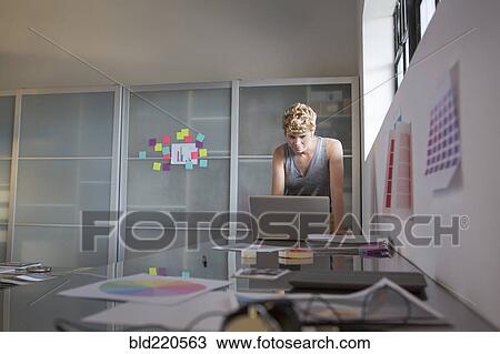 Stock Image - Caucasian businesswoman using computer in office. Fotosearch