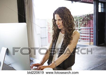 Caucasian businesswoman working on computer in office View Large Photo Image Stock Photo - Caucasian businesswoman working on computer in office. Fotosearch