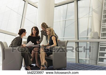 Caucasian businesswomen sitting in armchairs talking View Large Photo Image Stock Photo - Caucasian businesswomen sitting in armchairs talking. Fotosearch