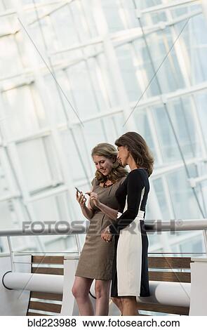 Caucasian businesswomen using cell phone View Large Photo Image Stock Photo - Caucasian businesswomen using cell phone. Fotosearch