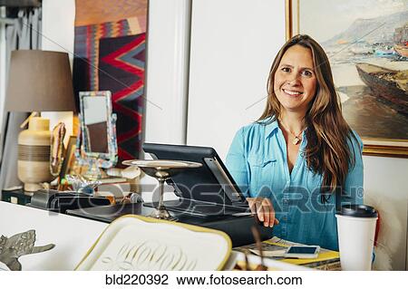 Caucasian clerk standing at register in store View Large Photo Image Stock Image - Caucasian clerk standing at register in store. Fotosearch