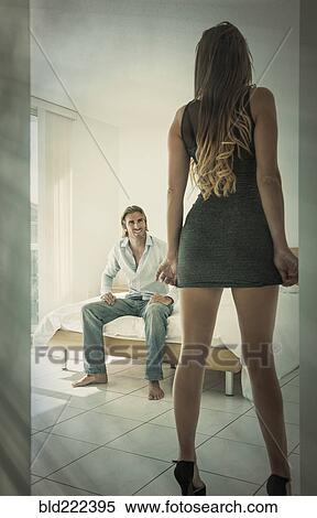 Stock Photography - Caucasian couple anticipating passion in bedroom. Fotosearch