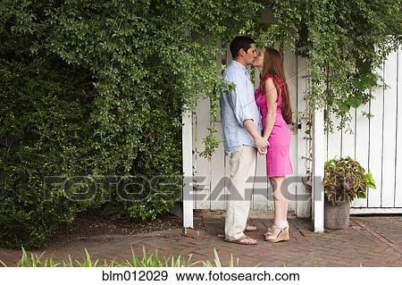 Caucasian couple holding hands and kissing View Large Photo Image Stock Photo - Caucasian couple holding hands and kissing. Fotosearch
