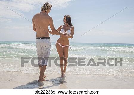Caucasian couple holding hands on beach View Large Photo Image Stock Photography - Caucasian couple holding hands on beach. Fotosearch