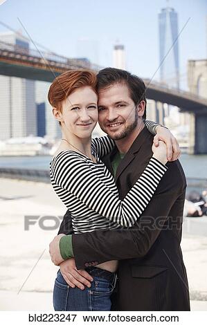 Caucasian couple hugging at waterfront View Large Photo Image Stock Photo - Caucasian couple hugging at waterfront. Fotosearch