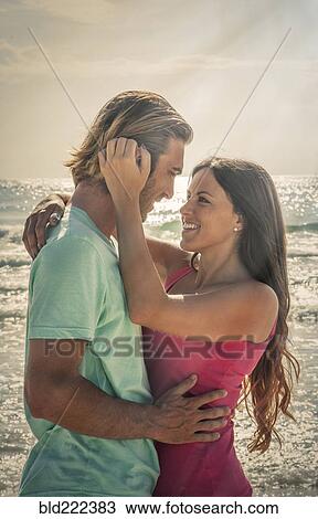 Caucasian couple hugging on beach View Large Photo Image Stock Image - Caucasian couple hugging on beach. Fotosearch