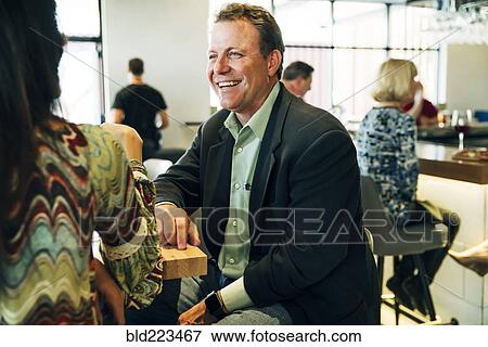 Caucasian couple smiling at restaurant View Large Photo Image Stock Photo - Caucasian couple smiling at restaurant . Fotosearch