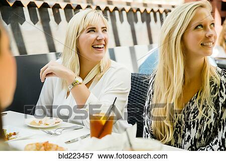 Stock Photo - Caucasian customers smiling in restaurant. Fotosearch