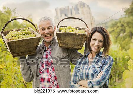 Caucasian farmers carrying grapes in vineyard View Large Photo Image Stock Photography - Caucasian farmers carrying grapes in vineyard. Fotosearch