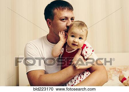 Caucasian father kissing baby daughter View Large Photo Image Stock Image - Caucasian father kissing baby daughter. Fotosearch