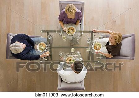Caucasian friends eating dinner together View Large Photo Image Stock Image - Caucasian friends eating dinner together. Fotosearch
