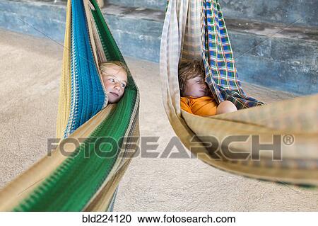 Caucasian girl in hammock checking on sleeping brother View Large Photo Image Stock Image - Caucasian girl in hammock checking on sleeping brother. Fotosearch