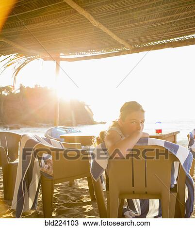 Caucasian girl sitting in chair at beach View Large Photo Image Stock Image - Caucasian girl sitting in chair at beach. Fotosearch