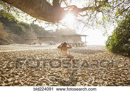 Caucasian girl sitting on tree swing View Large Photo Image Stock Image - Caucasian girl sitting on tree swing. Fotosearch