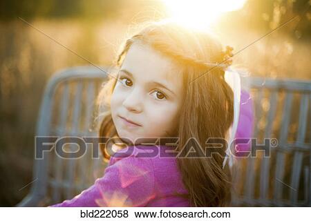 Stock Photo - Caucasian girl standing in field. Fotosearch