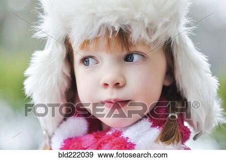 Stock Photo - Caucasian girl wearing fuzzy hat outdoors. Fotosearch