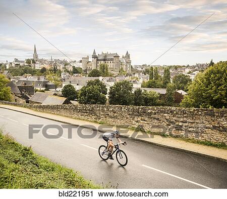 Stock Image - Caucasian man cycling outdoors. Fotosearch