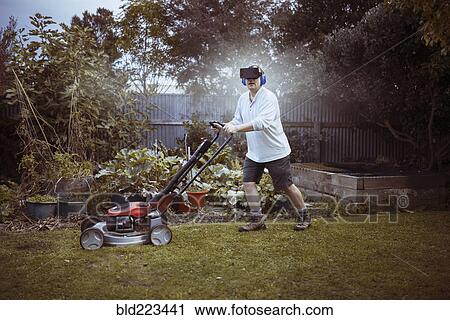 Caucasian man mowing lawn with VR goggles View Large Photo Image Stock Image - Caucasian man mowing lawn with VR goggles. Fotosearch