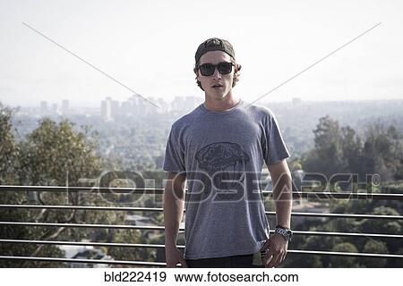 Caucasian man near railing overlooking scenic view of city View Large Photo Image Stock Photo - Caucasian man near railing overlooking scenic view of city. Fotosearch