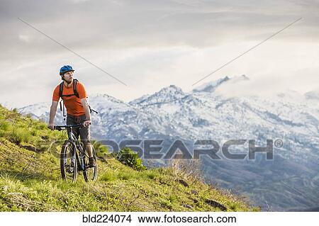 Caucasian man riding mountain bike View Large Photo Image Picture - Caucasian man riding mountain bike. Fotosearch