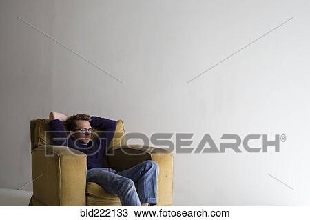 Caucasian man sitting in armchair View Large Photo Image Stock Image - Caucasian man sitting in armchair. Fotosearch