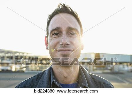 Stock Image - Caucasian man smiling outdoors. Fotosearch