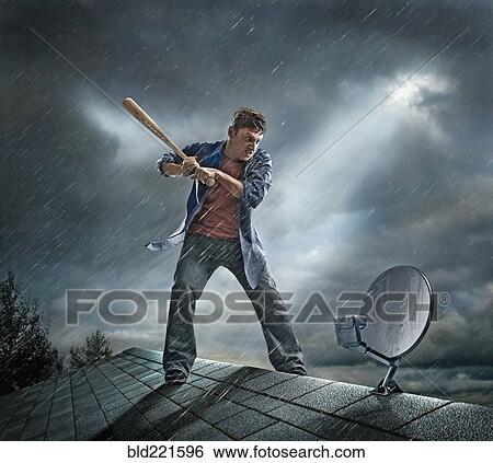 Caucasian man swinging baseball bat at satellite dish on roof View Large Photo Image Stock Photograph - Caucasian man swinging baseball bat at satellite dish on roof. Fotosearch