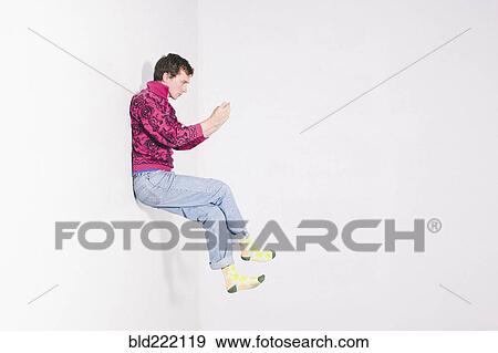Stock Photo - Caucasian man using cell phone in mid. Fotosearch