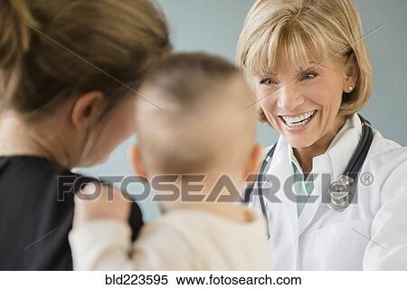 Stock Photography - Caucasian mother and daughter talking with doctor. Fotosearch
