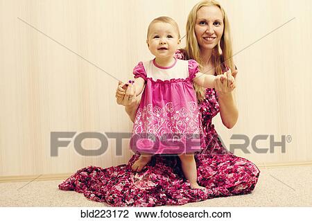 Caucasian mother helping baby daughter walk View Large Photo Image Stock Image - Caucasian mother helping baby daughter walk. Fotosearch