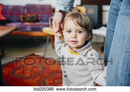 Stock Photograph - Caucasian mother helping baby son walk. Fotosearch
