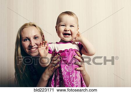 Caucasian mother holding baby daughter View Large Photo Image Stock Image - Caucasian mother holding baby daughter. Fotosearch