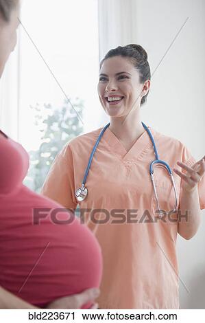 Caucasian nurse consulting with expectant mother View Large Photo Image Stock Image - Caucasian nurse consulting with expectant mother. Fotosearch