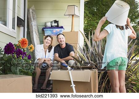 Caucasian parents watching daughter play outside house View Large Photo Image Stock Image - Caucasian parents watching daughter play outside house. Fotosearch