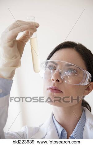 Caucasian scientist holding vial View Large Photo Image Stock Photo - Caucasian scientist holding vial. Fotosearch