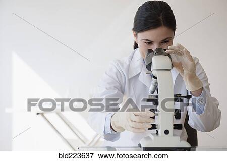 Caucasian scientist using microscope View Large Photo Image Stock Photo - Caucasian scientist using microscope. Fotosearch