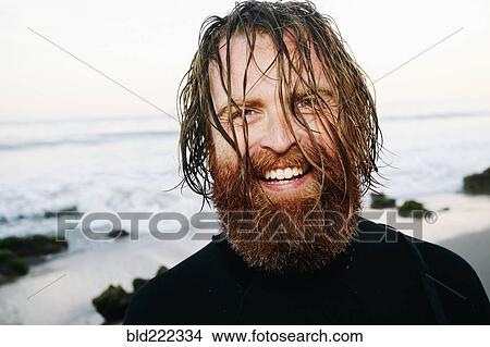 Caucasian surfer with wet hair at beach View Large Photo Image Picture - Caucasian surfer with wet hair at beach. Fotosearch